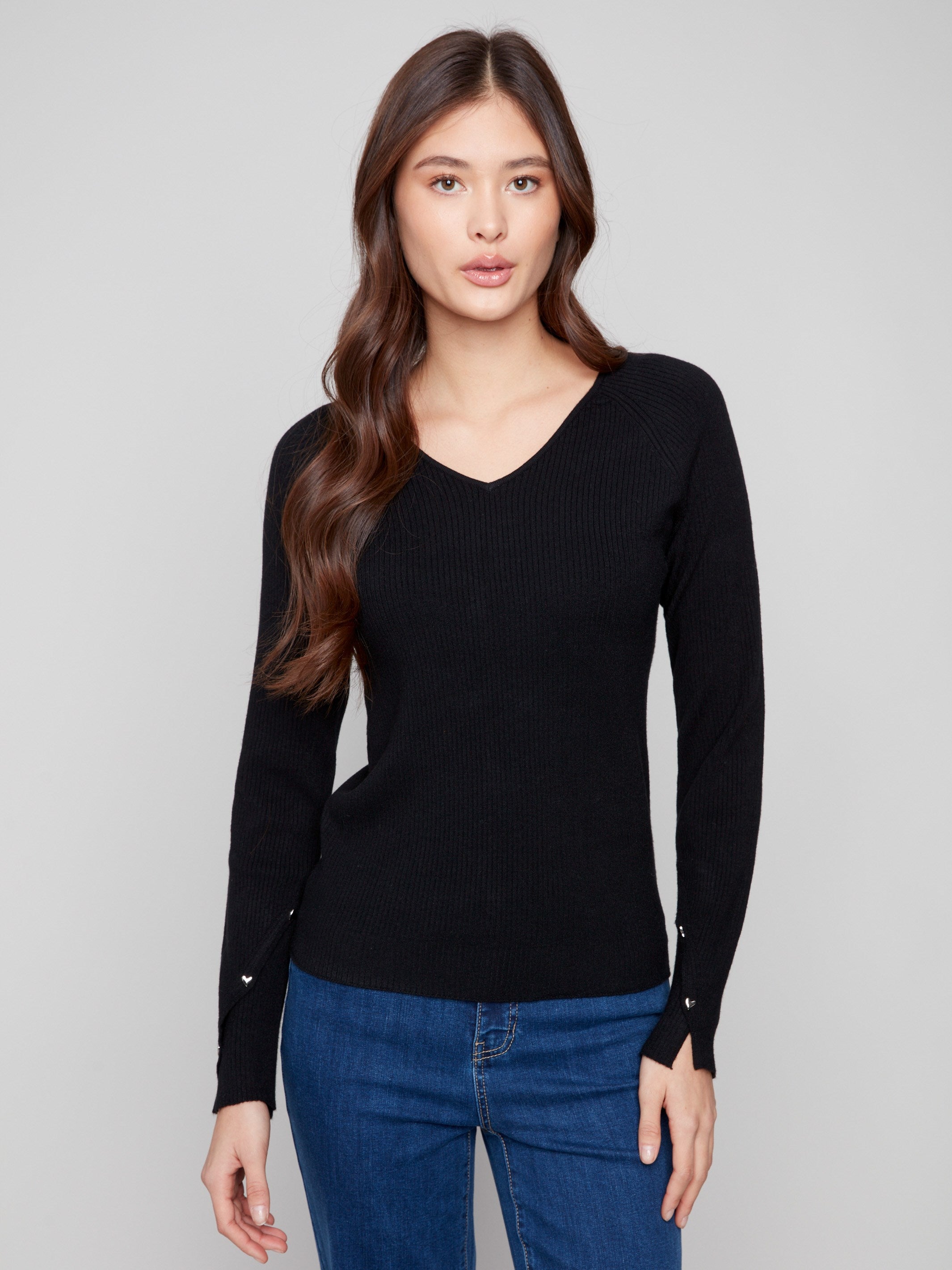 Black sweater featuring a slim fit and heart rivets on the sleeves, perfect for a chic silhouette by Charlie B.