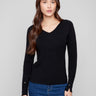Black sweater featuring a slim fit and heart rivets on the sleeves, perfect for a chic silhouette by Charlie B.