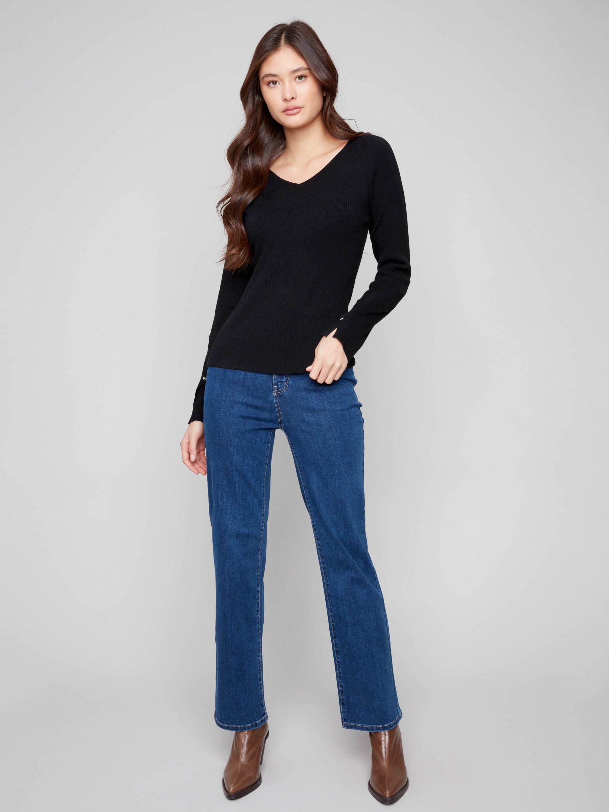 Elegant black sweater with ribbed texture and heart rivets adding charm to the look by Charlie B.