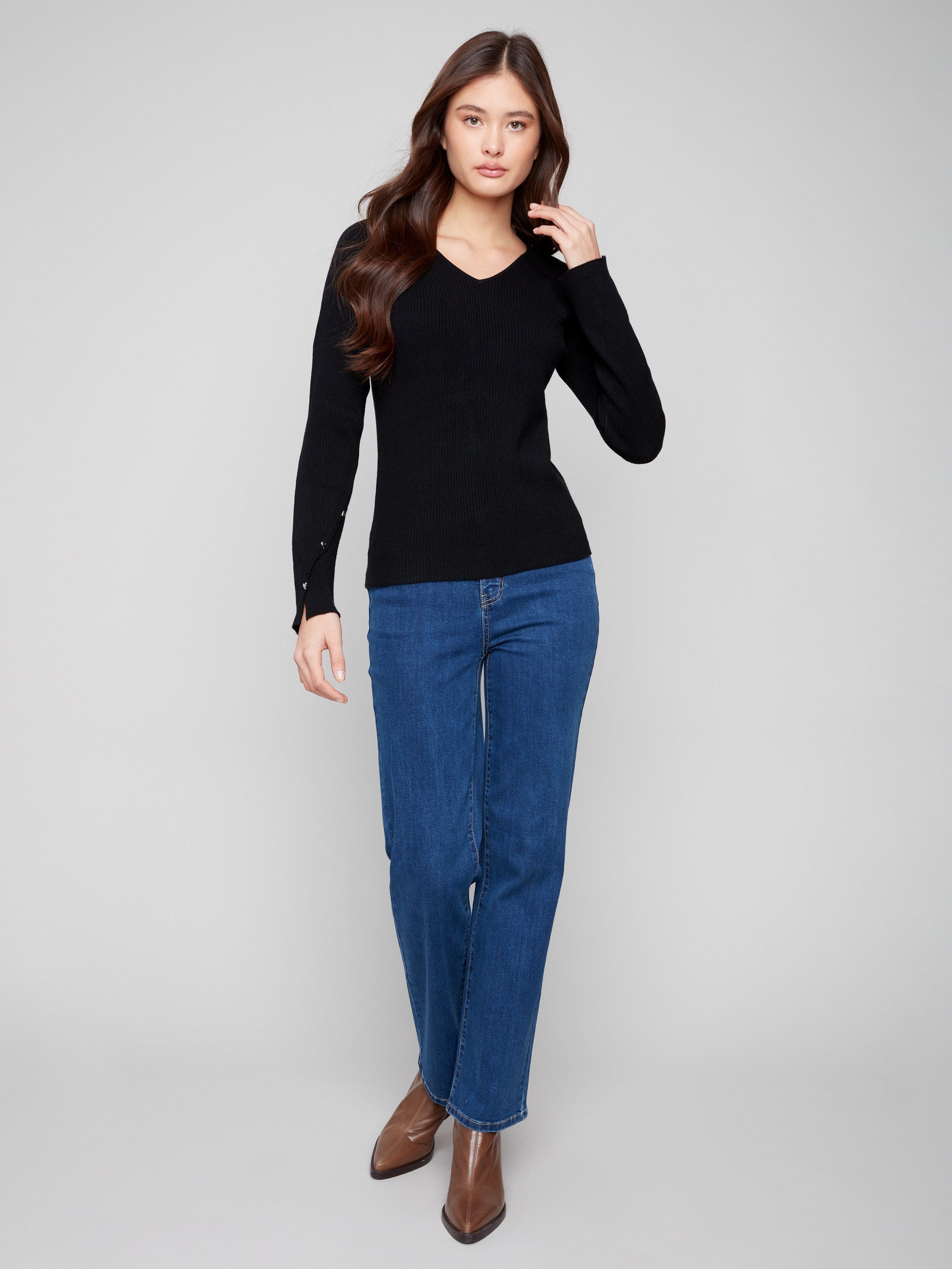 Chic black ribbed sweater showcasing a flattering slim fit and charming heart rivets by Charlie B.