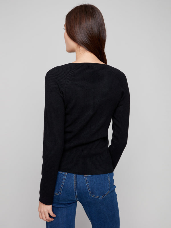 Sophisticated black sweater with subtle ribbed texture, complemented by elegant slit cuffs by Charlie B.