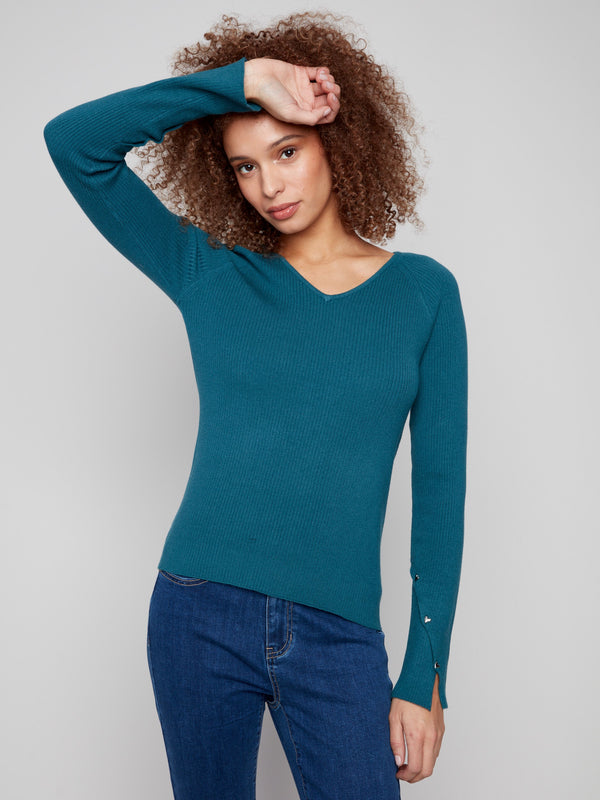 Elegant evergreen sweater with slit cuffs and heart rivet details, perfect for a refined look by Charlie B.