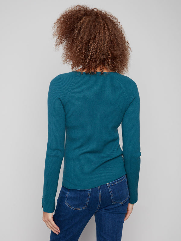 Trendy ribbed V-neck sweater in an evergreen hue, complete with unique heart rivet accents on the sleeves by Charlie B.