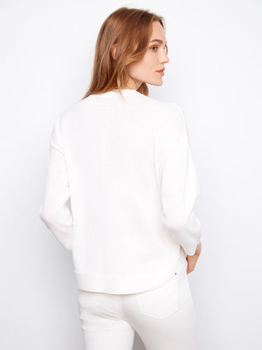 White sweater showcasing a rounded hem and crafted from soft 100% cotton for everyday wear by Charlie B.