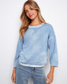 Soft blue top with a classic crew neckline, offering a relaxed fit ideal for casual wear. Crafted from 100% cotton by Charlie B.