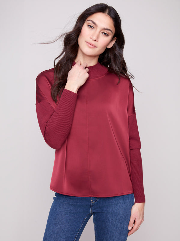 Cabernet satin knit top with ribbed cuffs and neckline, offering a cozy yet chic look by Charlie B.