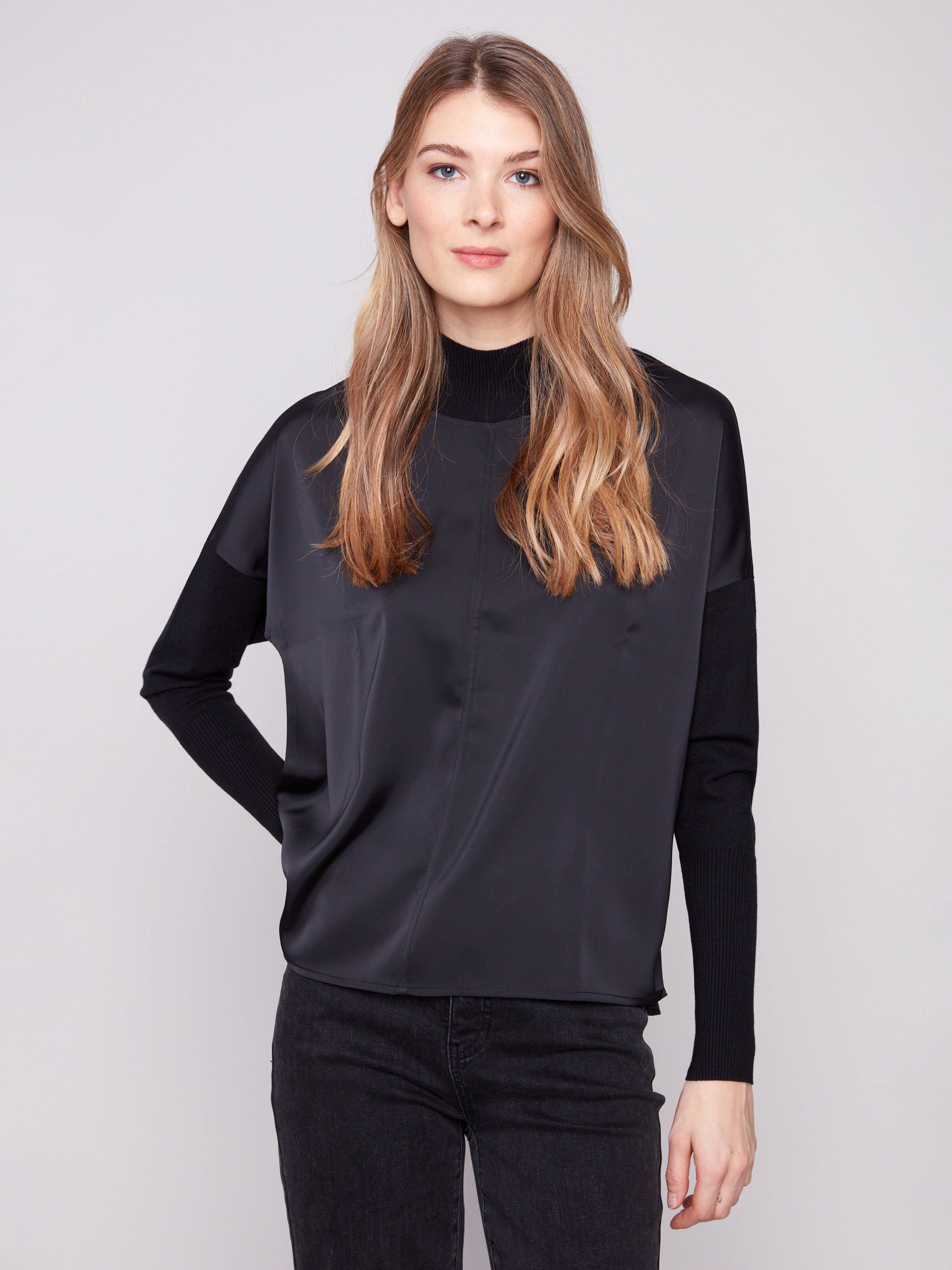 Black satin knit top with drop shoulders and ribbed cuffs, crafted for a sleek look by Charlie B.