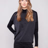 Black satin knit top with drop shoulders and ribbed cuffs, crafted for a sleek look by Charlie B.