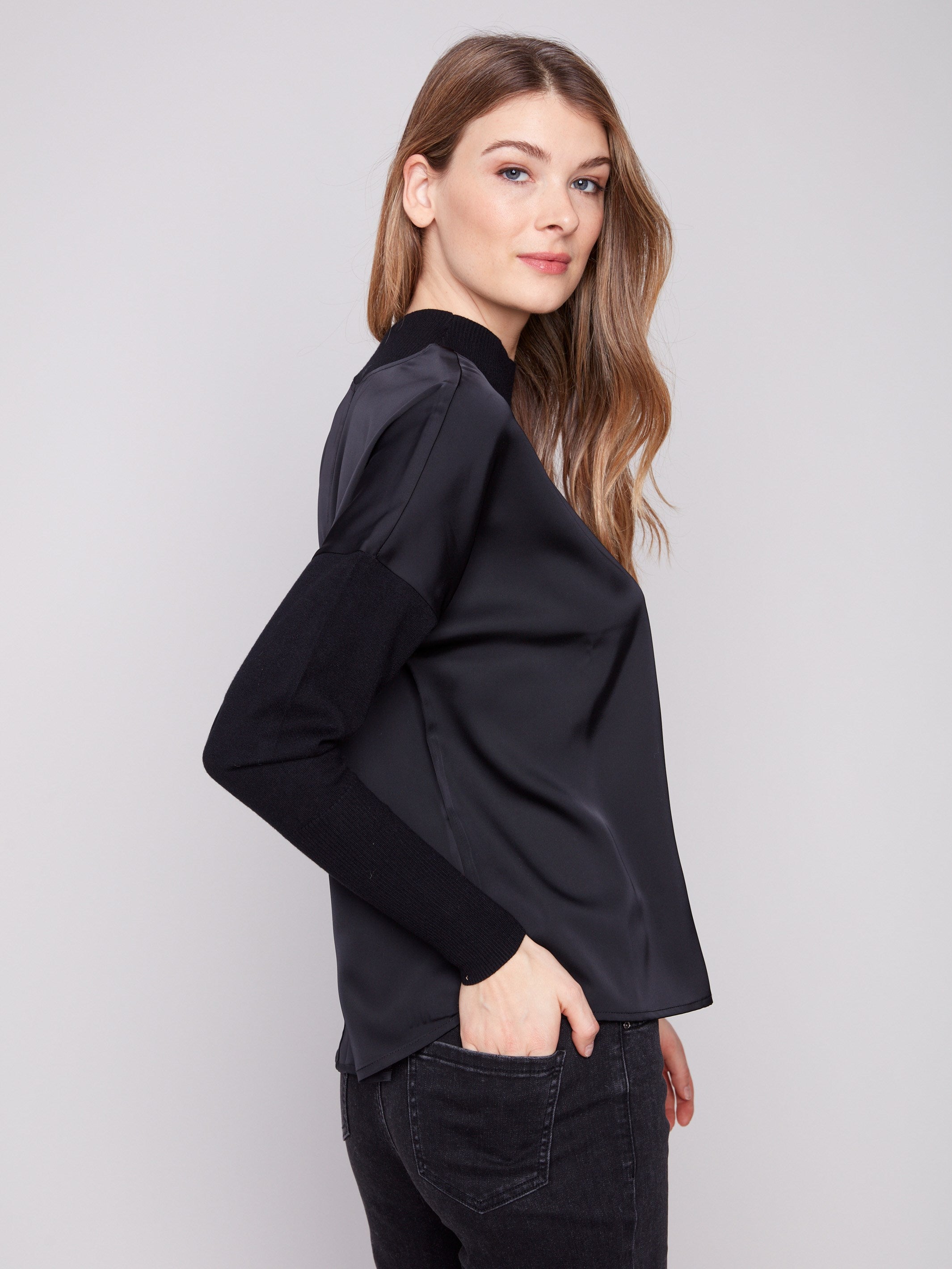 Chic black top featuring mock neck and seamless design, perfect for any occasion by Charlie B.
