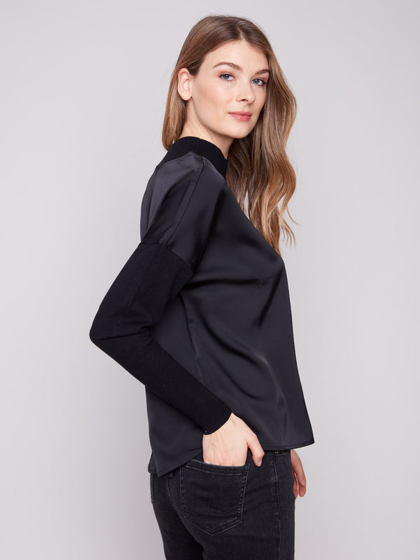 Chic black top featuring mock neck and seamless design, perfect for any occasion by Charlie B.