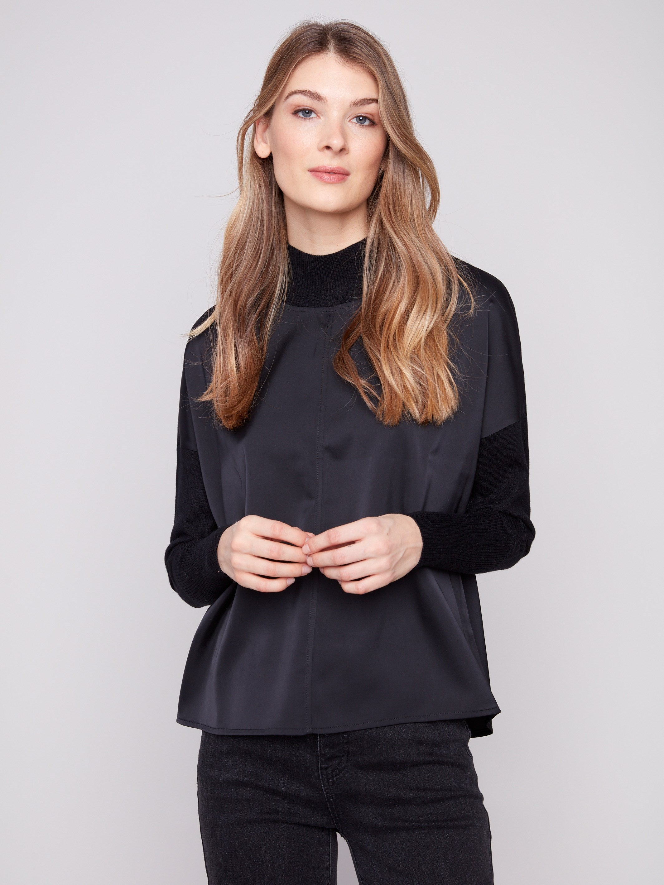 Stylish satin knit top with front seam detail and drop shoulders, offering modern elegance by Charlie B.
