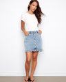 Denim skirt with front buttons, offering a stylish look and convenient wear. The short length adds a modern touch. By Charlie B.