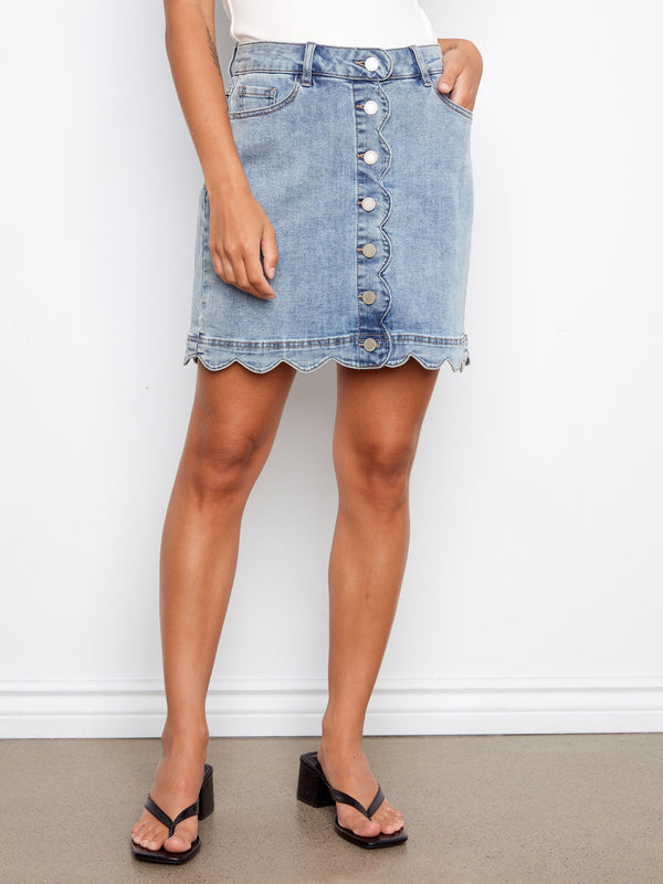 Scalloped hem detail gives an extra feminine touch to the overall design of this trendy stretch denim skirt. By Charlie B.