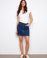 Indigo denim skort with a short length and five-pocket style, featuring a scalloped hem. Perfect for casual outings by Charlie B.