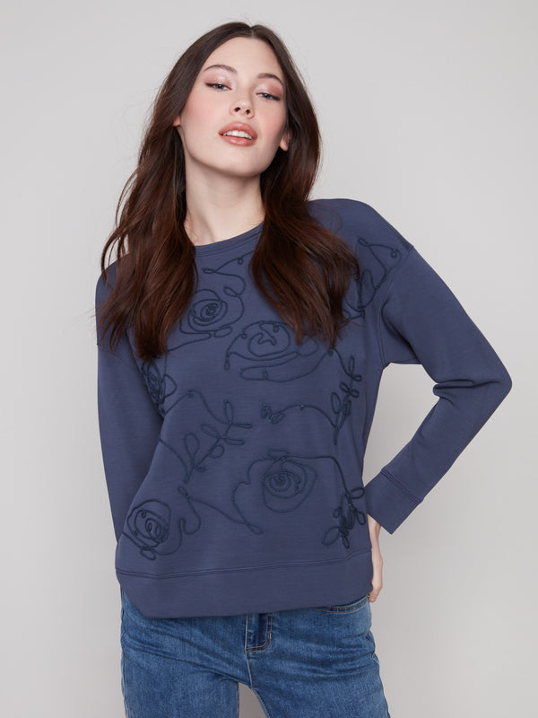 Stylish Moonlight Scuba Knit Top enhanced with a unique soutache pattern, adding flair to your wardrobe by Charlie B.