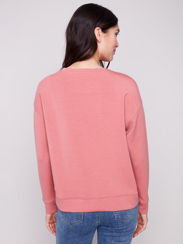 The Primrose Scuba Knit Top offers a seamless blend of style and simplicity with its minimalist back design for everyday wear by Charlie B.