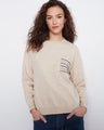 Almond sweater featuring drop shoulders and a sequin-striped pocket, perfect for casual elegance by Charlie B.