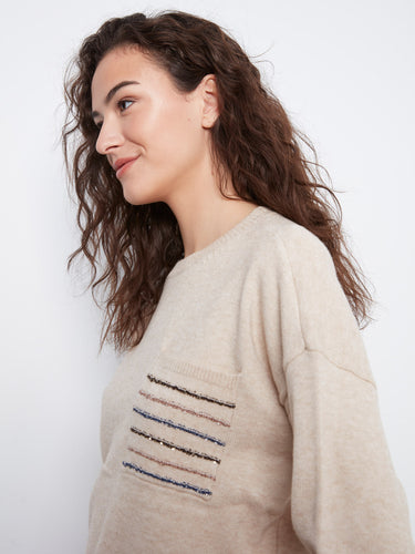 Elegant almond sweater designed with drop shoulders and a unique sequin-striped pocket by Charlie B.