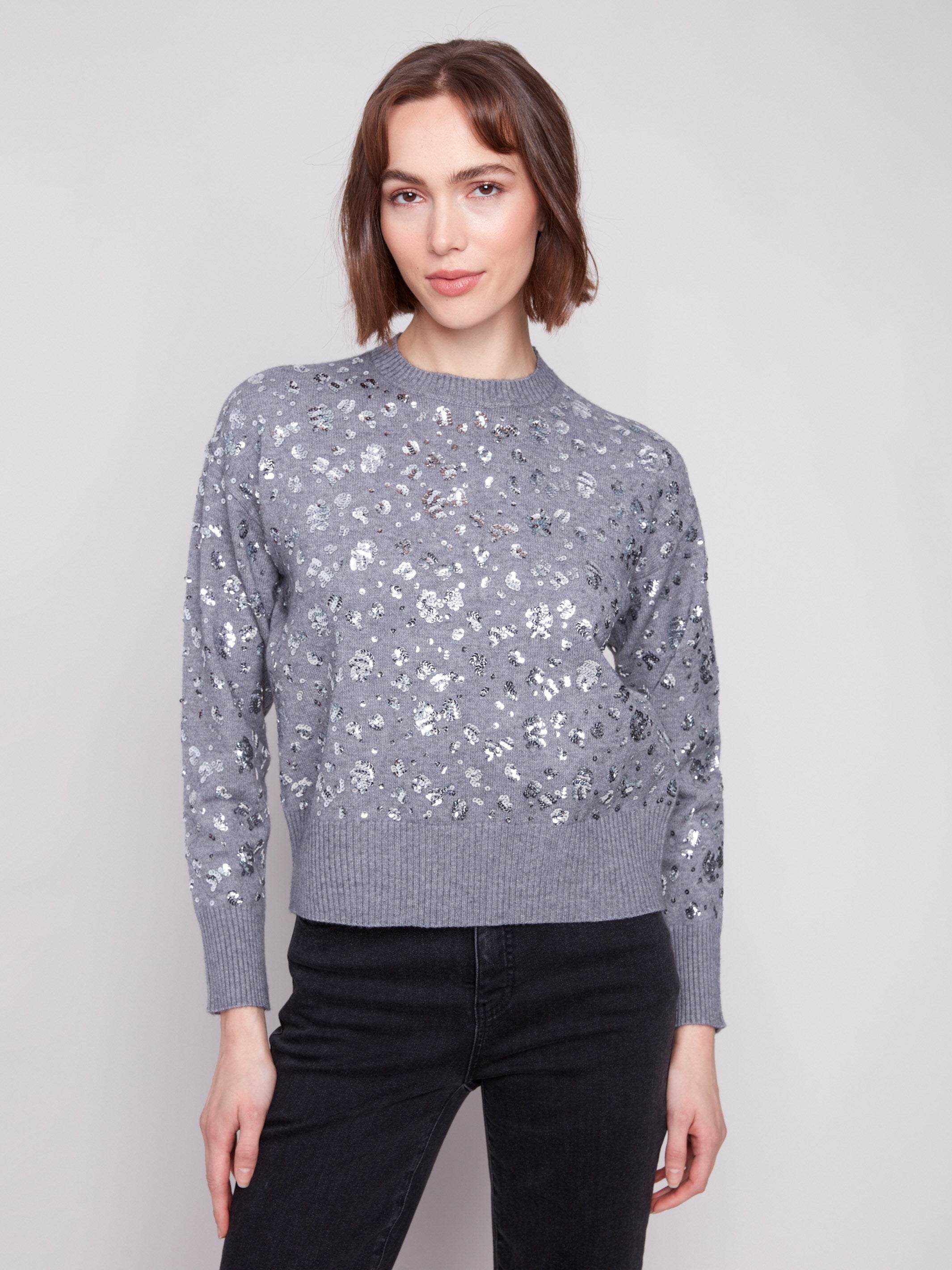 Heather grey sweater featuring a drop shoulder design with shimmering sequins for added style by Charlie B.