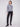 This slightly cropped sweater in dark grey showcases a sparkling sequin pattern, perfect for a chic look by Charlie B.