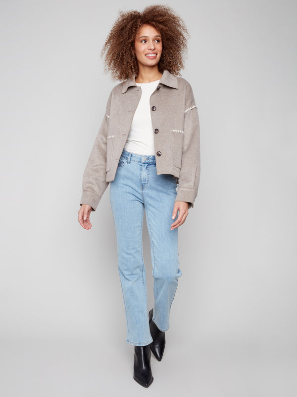 Elegant double-face wool jacket showcasing intricate blanket stitch detailing for a unique touch by Charlie B.
