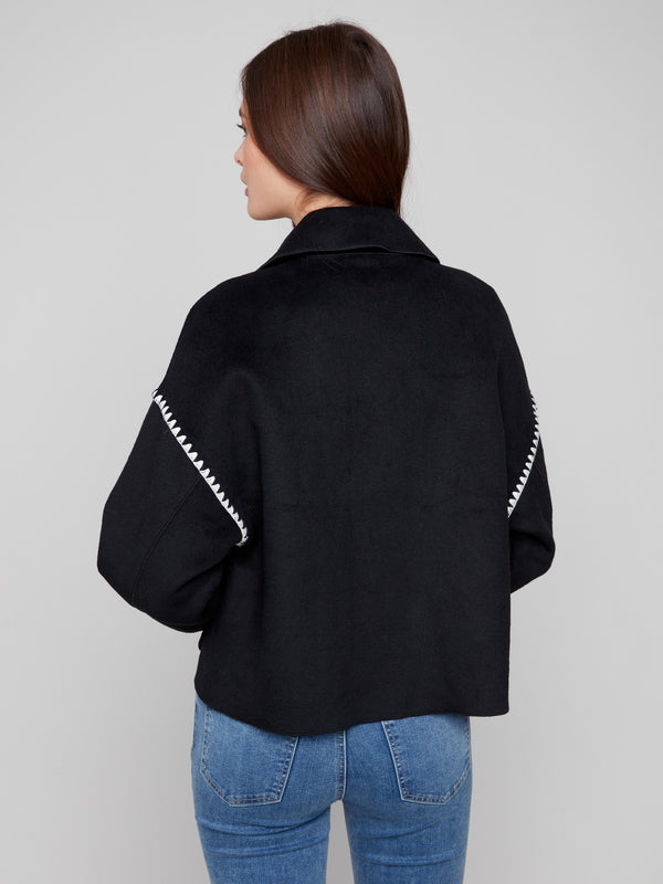 Elegant black jacket showcasing intricate blanket stitch detailing for a unique fashion statement by Charlie B.