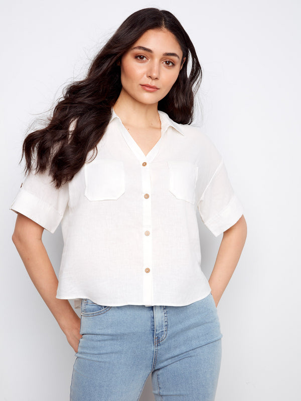 Button-front design on this white shirt provides an easy-to-wear style that pairs well with jeans or skirts by Charlie B.