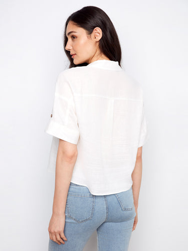 Elegant white shirt includes functional chest pockets, offering both style and practicality for everyday wear by Charlie B.