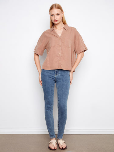 Showcasing short sleeves with button tabs, this versatile shirt offers comfort and style for any wardrobe by Charlie B.
