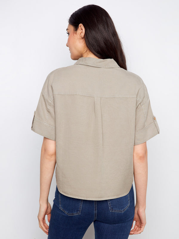 Minimalist design with a focus on comfort and ease, highlighted by its simple button-front closure. By Charlie B.