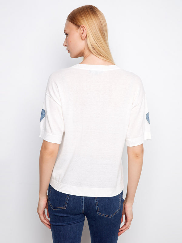 Comfortable white sweater showcasing a classic crew neckline and distinctive denim heart accents by Charlie B.
