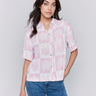 Pink blouse with a classic shirt collar and shell print by Charlie B.
