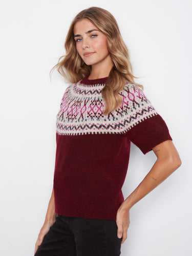 Adorned with a geometric pattern, this sweater brings a modern twist to traditional knitwear, enhancing any wardrobe. By Charlie B.