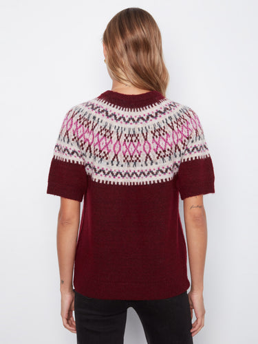 The intricate geometric pattern on the back adds visual interest and uniqueness to the overall look of the sweater. By Charlie B.