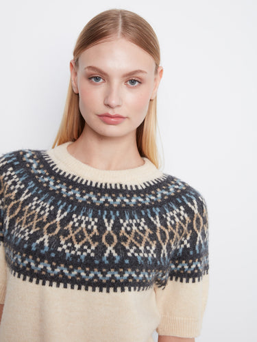 Chic ecru sweater adorned with a striking geometric pattern around the neckline by Charlie B.
