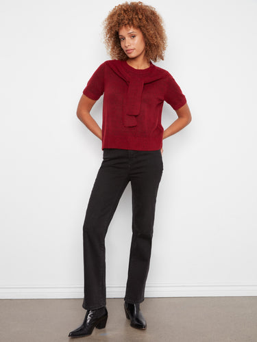 Elegant red top in soft knit fabric, highlighted by its distinctive attached sweater detail for a chic touch by Charlie B.