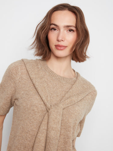 The attached sweater detail on this beige top adds a unique touch to its classic design, making it versatile by Charlie B.