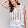 Sleeveless white top featuring a crochet texture by Charlie B.