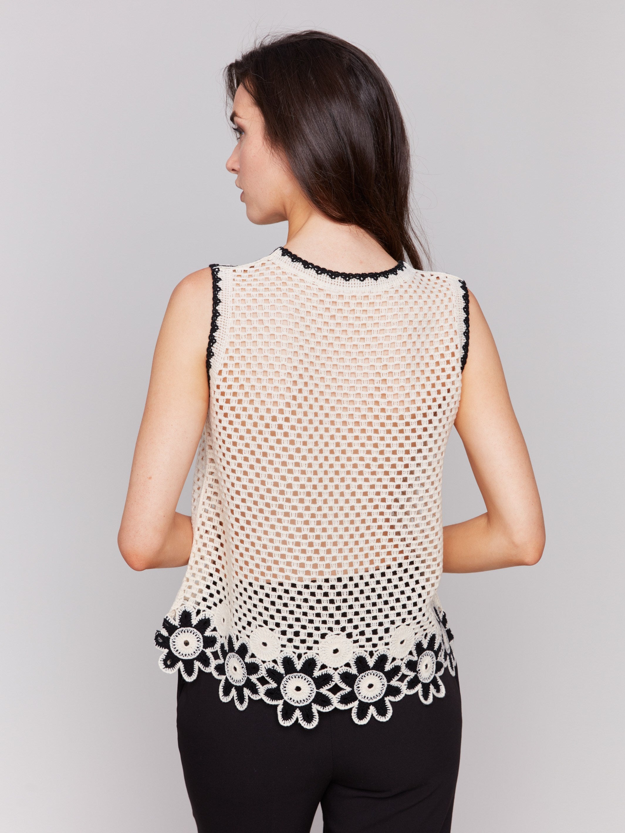 Elegant floral crochet border adds charm to this natural top by Charlie B.