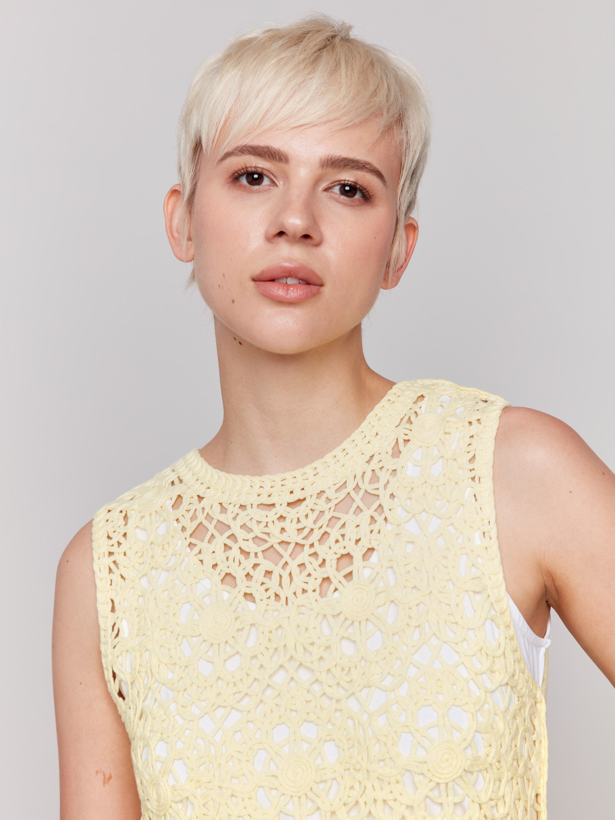 Sleeveless lemonade crochet top featuring a crew neckline by Charlie B.