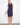 Navy sleeveless shift dress featuring a straight silhouette and decorative side button details by Charlie B.
