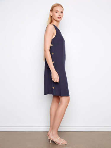 Navy shift dress with a knee-length hemline and charming side button accents by Charlie B.