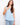 Light blue sleeveless top with a scoop neckline, featuring side button detailing for a stylish touch. By Charlie B.