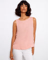 This sleeveless top features a scoop neckline and is crafted in a soft, blush pink fabric with side button detailing by Charlie B.