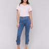Pull-on style medium blue jeans with floral accents by Charlie B.