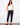 Black slim-fit pants with stretch twill fabric and a belt, ideal for comfort and style by Charlie B.