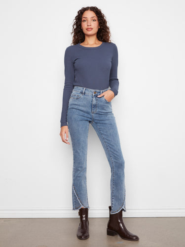Denim jeans with a slim fit and a stylish tulip hem adorned with studs, perfect for any casual outing. By Charlie B.