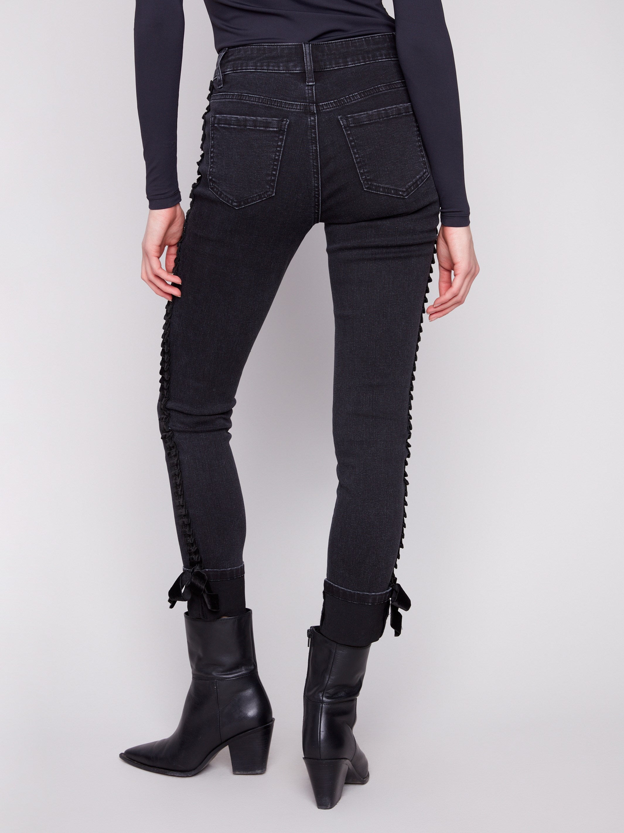 Stylish ankle-length charcoal jeans with unique velvet bow trim along the side seams by Charlie B.