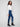 Ankle-length indigo jeans with velvet bow trim along the side seams for added flair by Charlie B.