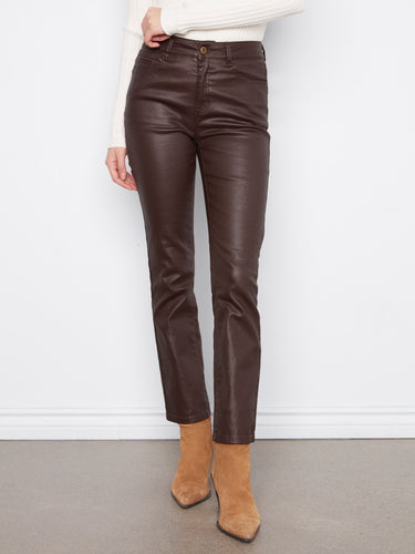 Model showcasing coffee-colored stretch twill pants with five pockets, styled with a white top and brown ankle boots by Charlie B.